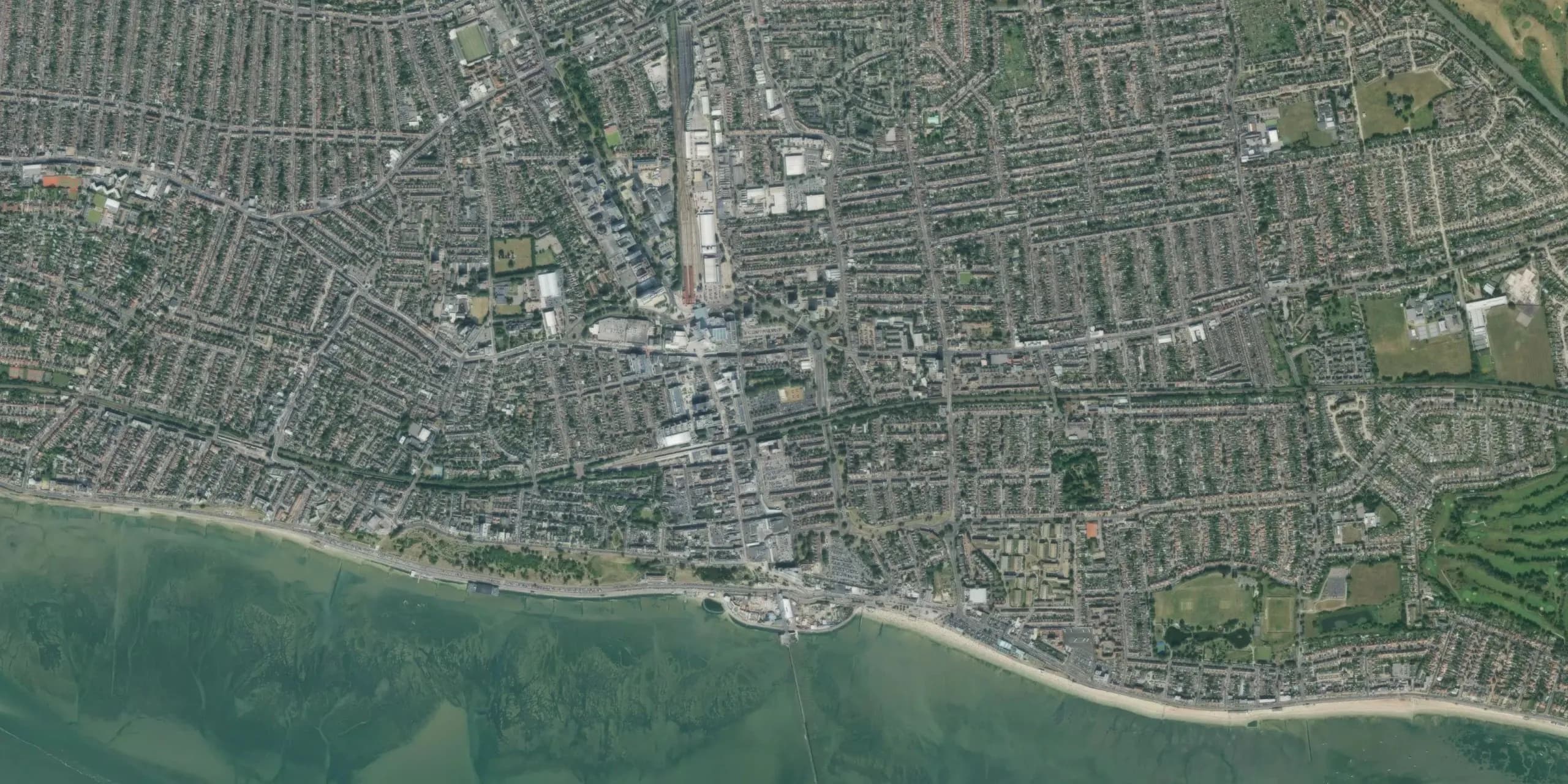 Aerial view of an estuary edge where farmland meets tidal water