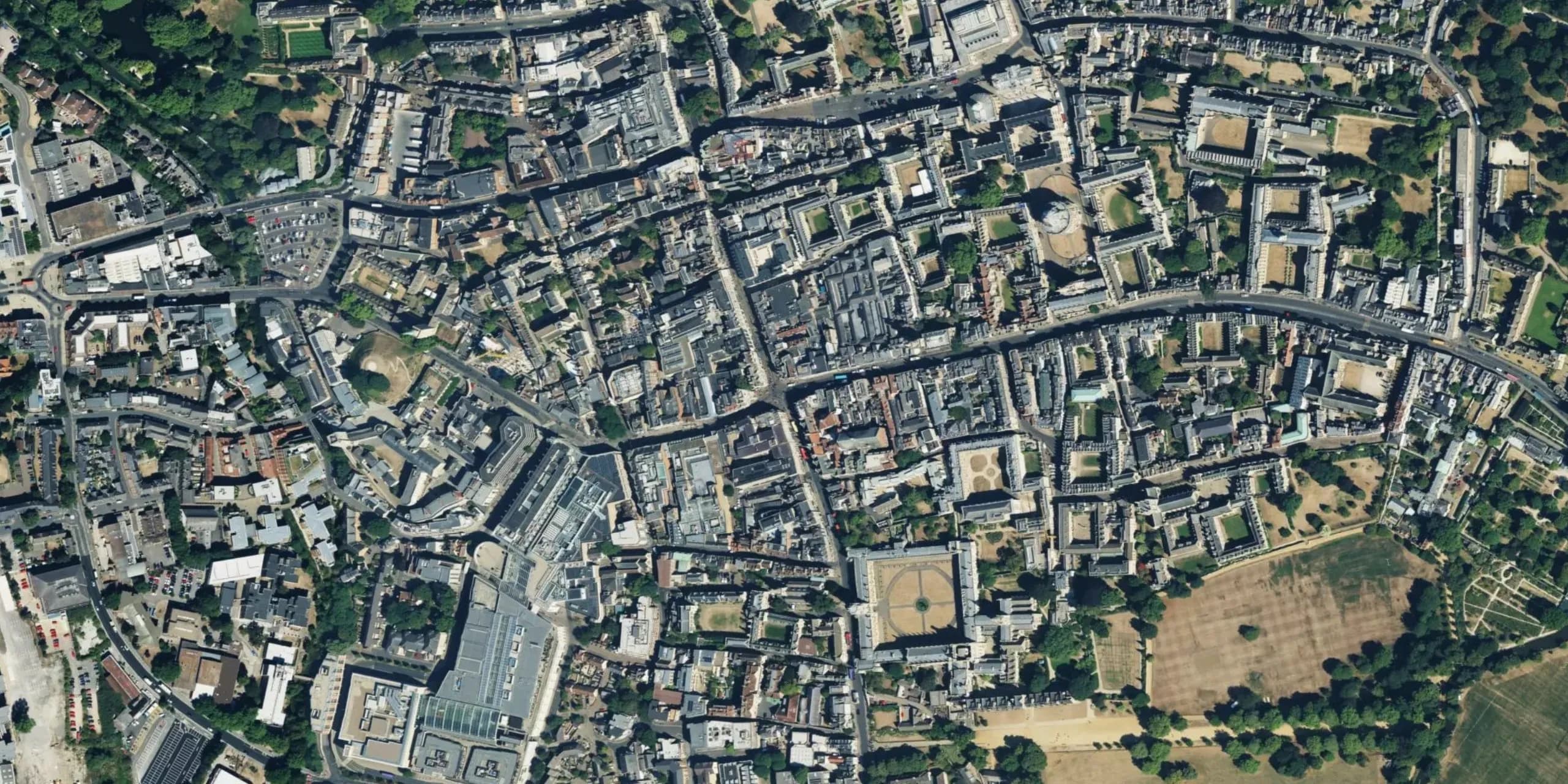 Aerial view of the edge of a settlement where fields meet housing